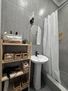 ein Badezimmer mit Waschbecken und Spiegel in der Unterkunft EmmaApart Comfort 11 in Astana