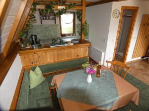 a dining room with a table and a kitchen at Ferienhaus in Sebnitz in Sebnitz