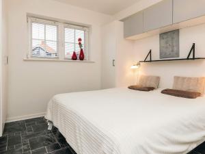 a bedroom with a large white bed with two pillows at 4 star holiday home in Bogense-By Traum in Bogense