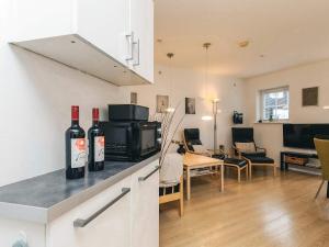 a kitchen with two bottles of wine on a counter at 4 star holiday home in Bogense-By Traum in Bogense +45 photos
