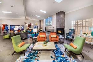 a large living room with colorful furniture and a fireplace at San Clemente Inn in San Clemente