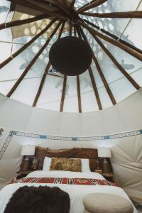 Postel nebo postele na pokoji v ubytování Oso Tipi at El Mistico Ranch