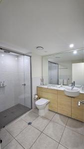 a bathroom with a shower and a toilet and a sink at Water Views Studio in Nelly Bay
