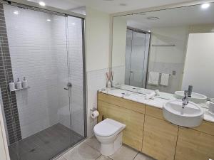 a bathroom with a shower and a toilet and a sink at Water Views Studio in Nelly Bay +29 photos