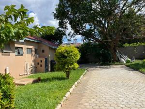 a brick driveway in front of a house at Ruby's Haven in Lusaka