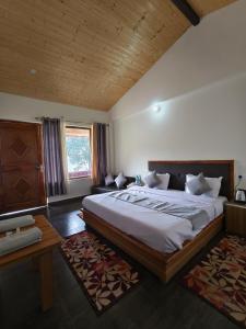 a bedroom with a large bed in a room at Naina Bird Cottage in Nainital