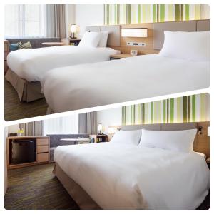 大町市Holiday Inn Resort Shinano-Omachi Kuroyon by IHG的两张带两张床的酒店客房的照片