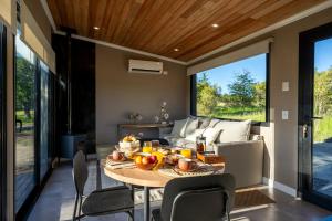 a dining room with a table and a couch at Tylluan Lodge in Trevelín