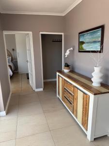 a living room with a tv on a wall at Luxury Beachfront Villa in Langebaan
