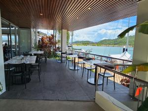 a restaurant with tables and chairs and a view of the water at Water Views Studio in Nelly Bay