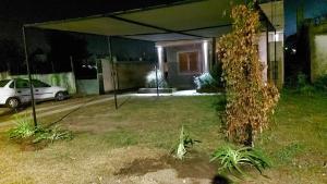 a house with a car parked in a yard at night at Departamento Cerca Parque Termal Rodo-Hue 2 in Dolores