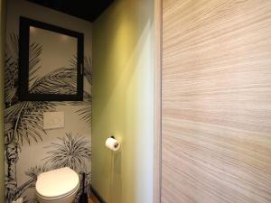 a bathroom with a toilet and a mirror at Appart rénové T2 bis, centre La Bourboule, WiFi, proche thermes - FR-1-608-277 in La Bourboule +11 photos