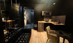 a black room with a counter and a kitchen with a sink at Chill & SPA in Dunkerque