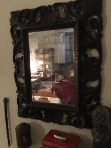 a mirror hanging on a wall in a room at Il Pioppo Antico in Viggiù