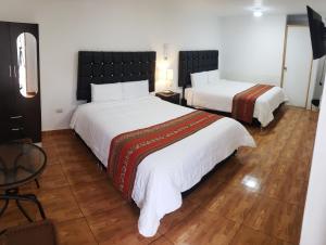 Postel nebo postele na pokoji v ubytování Cusco de mis Sueños Hostal - II