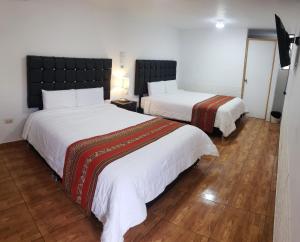 Postel nebo postele na pokoji v ubytování Cusco de mis Sueños Hostal - II