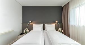 Postelja oz. postelje v sobi nastanitve PLAZA INN Graz