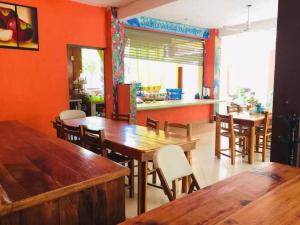a dining room with wooden tables and chairs at Hotel Acapulco Club Diamante in Acapulco