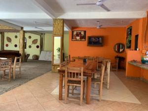 a dining room with a wooden table and chairs at Hotel Acapulco Club Diamante in Acapulco