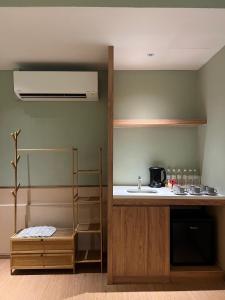 a kitchen with a sink and a counter at Swiss Hotel Heritage Boutique Melaka in Melaka