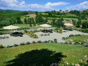 an aerial view of a garden with tables and umbrellas at Ca' Villa Club Agriturismo in Gabiano