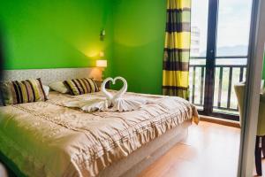 a bedroom with a bed with a swan on it at Hotel Walter in Sarajevo