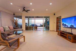 a living room with a large flat screen tv at Karon Bliss: 4 Bedroom Haven in Karon Beach
