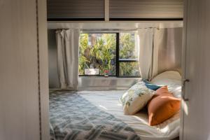 a bedroom with a canopy bed with a window at 橘舍三食OrangeFarmerlife in Miaoli