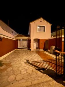 a house at night with a stone driveway at Casa la Serena Puertas del mar in La Serena