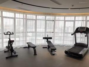 玉林Yishang Hotel Yulin Rongxian Rongzhou Commercial Plaza Branch的带窗户的房间里有带心肺功能器材的健身房