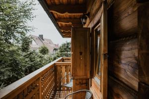 an open door to a porch on a wooden house at Willa Malinowa in Zakopane
