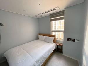Postel nebo postele na pokoji v ubytování Hotel Haeundae Elysia