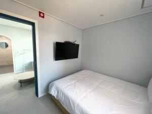 Postel nebo postele na pokoji v ubytování Hotel Haeundae Elysia