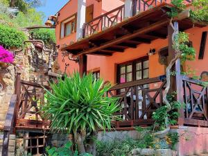 an orange house with a plant in front of it at Villetta Blu in Rio nellʼElba