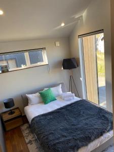 a bedroom with a large bed and a window at Niseko Forest Avenue 63 in Niseko