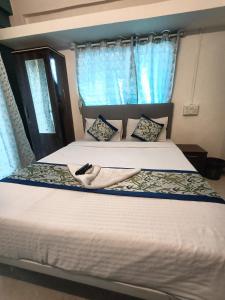 Postel nebo postele na pokoji v ubytování Hotel Silverleaf Residency + 2 fotografie