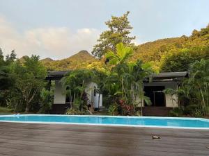 a house with a swimming pool in front of it at 7Senses Resort in Ko Chang