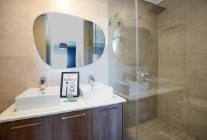 a bathroom with two sinks and a mirror at Waters Edge in Cape Town +22 photos