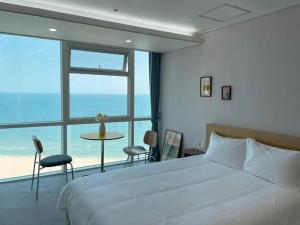 Postel nebo postele na pokoji v ubytování Hotel Haeundae Elysia
