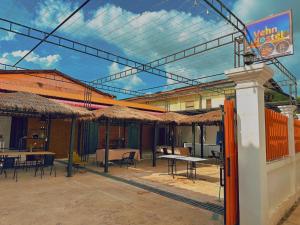 a patio with tables and umbrellas with tables and chairs at venn in Vientiane