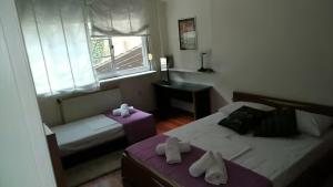 a small bedroom with two beds and a window at Villa Maira 2, Amazing Family apartment, 3 bedrooms, Swimming Pool, 150m to beach in Perea
