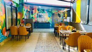 a restaurant with tables and chairs and a colorful wall at The Shankara View in Godarpura +16 photos
