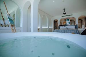 a bath tub in a room with a bed at Lakeside Retreat - LuguLake Lijiang in Zuosuo
