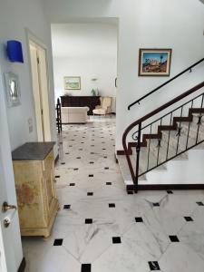a room with a staircase and a tile floor at Casa Rosella in Albenga