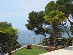 a view of the ocean from a resort with palm trees at Blueview Villa in Llafranc