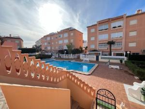 a building with a swimming pool and some buildings at Chalet La Mata in Torrevieja