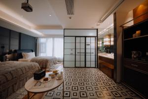 a hotel room with two beds and a table and a sink at Lakeside Retreat - LuguLake Lijiang in Zuosuo