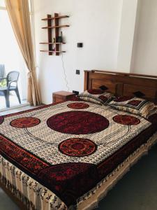 a large bed with a quilt on it in a bedroom at Sunset Haven in Habaraduwa Central
