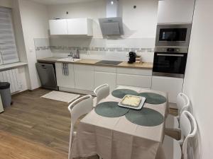 a kitchen with a table with a cake on it at Appart cosy Jalila in Lampertheim