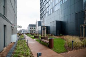 a building with a bench in front of a building at Global Apartments Katowice in Katowice